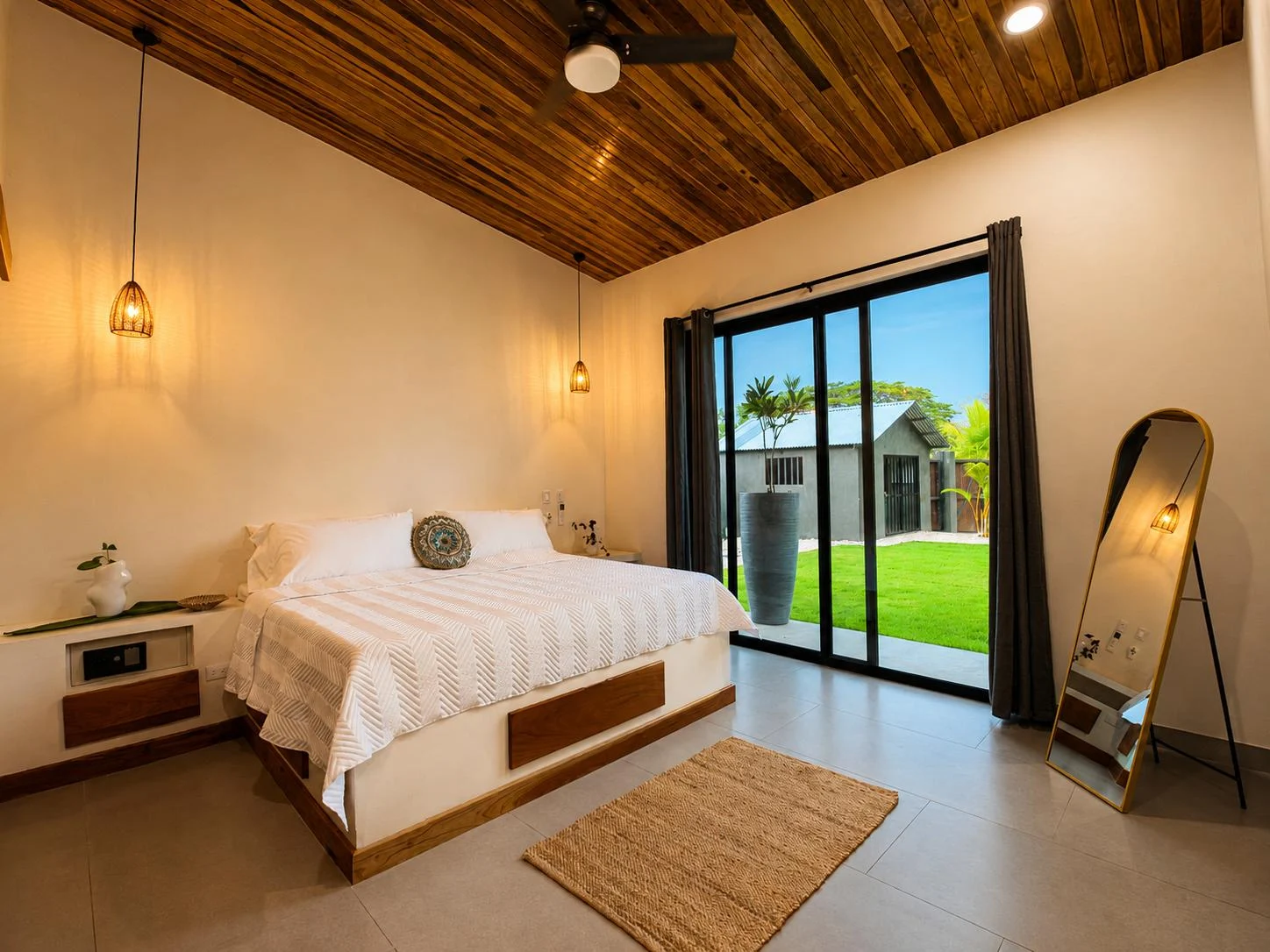A light-filled bedroom opening directly onto the villa garden
